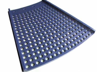 A piece of blue polyurethane trommel screen with round holes.