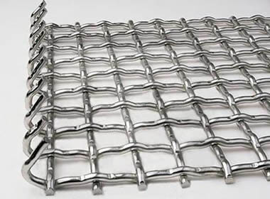 A piece of woven vibrating screen mesh with bending hook on the gray background.