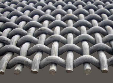 A piece of pre-crimped woven vibrating screen mesh on the gray background.