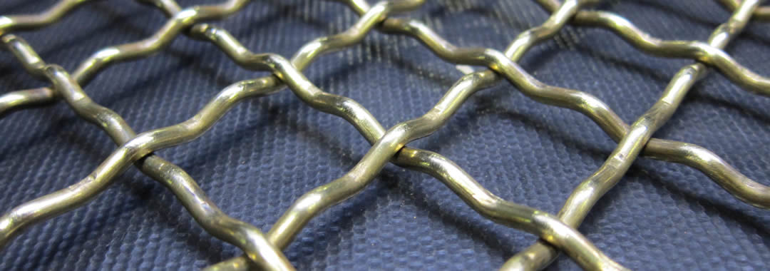 A piece of intermediate crimped woven vibrating screen mesh on the blue table.