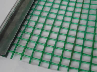 A piece of green steel core polyurethane screen on the gray background.